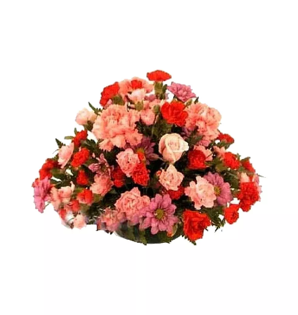 Rounded centerpiece arrangement in red and pink tones